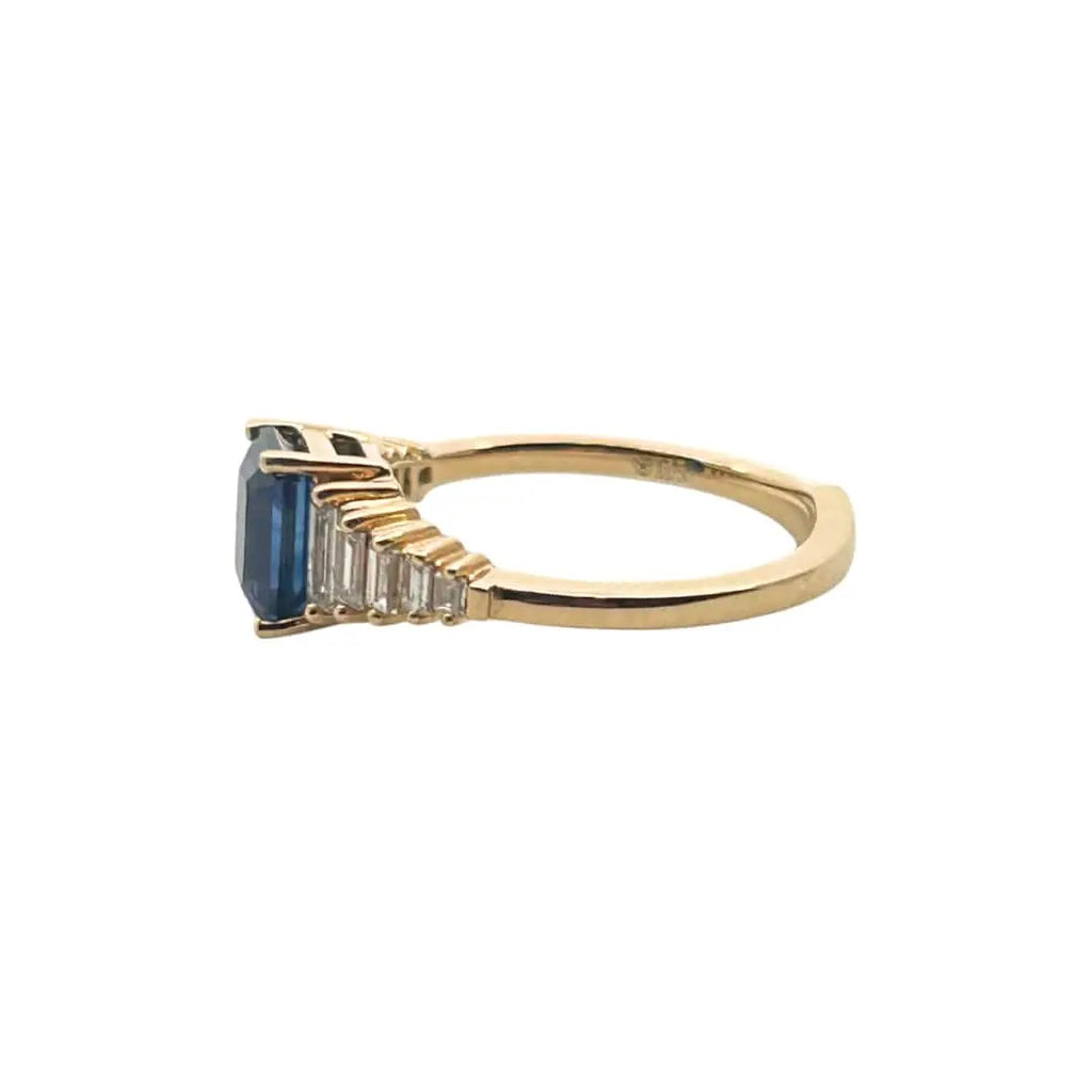 Emerald-cut sapphire and tapered baguette diamond ring – angled view
