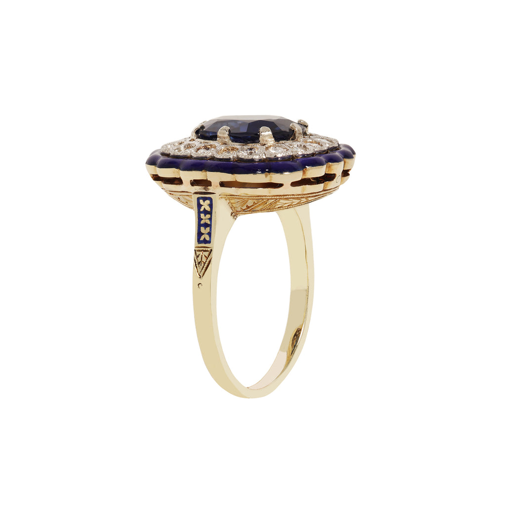 Blue sapphire ring with European-cut diamonds, cobalt enamel frame, platinum, and 14K gold accents. Side view.