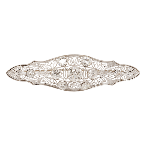 Edwardian navetted-shaped brooch with 9 European-cut bezel  diamonds and delicate openwork.