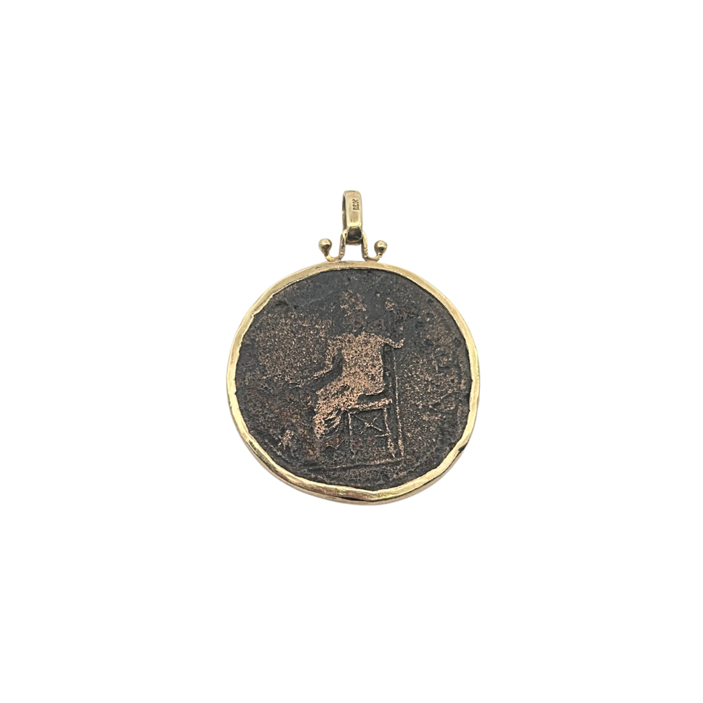Reverse side of ancient Roman bronze coin pendant showing seated figure in 14K gold bezel.