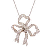 Front view of Edwardian diamond bow pendant in platinum with pavé old mine–cut diamonds on cable chain.