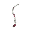 Elegant platinum bracelet with ruby cabochons and sparkling diamond rows shown in angled full-length view.