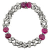 Circular view of Art Deco bracelet featuring ruby cabochons and bezel-set diamonds in platinum.
