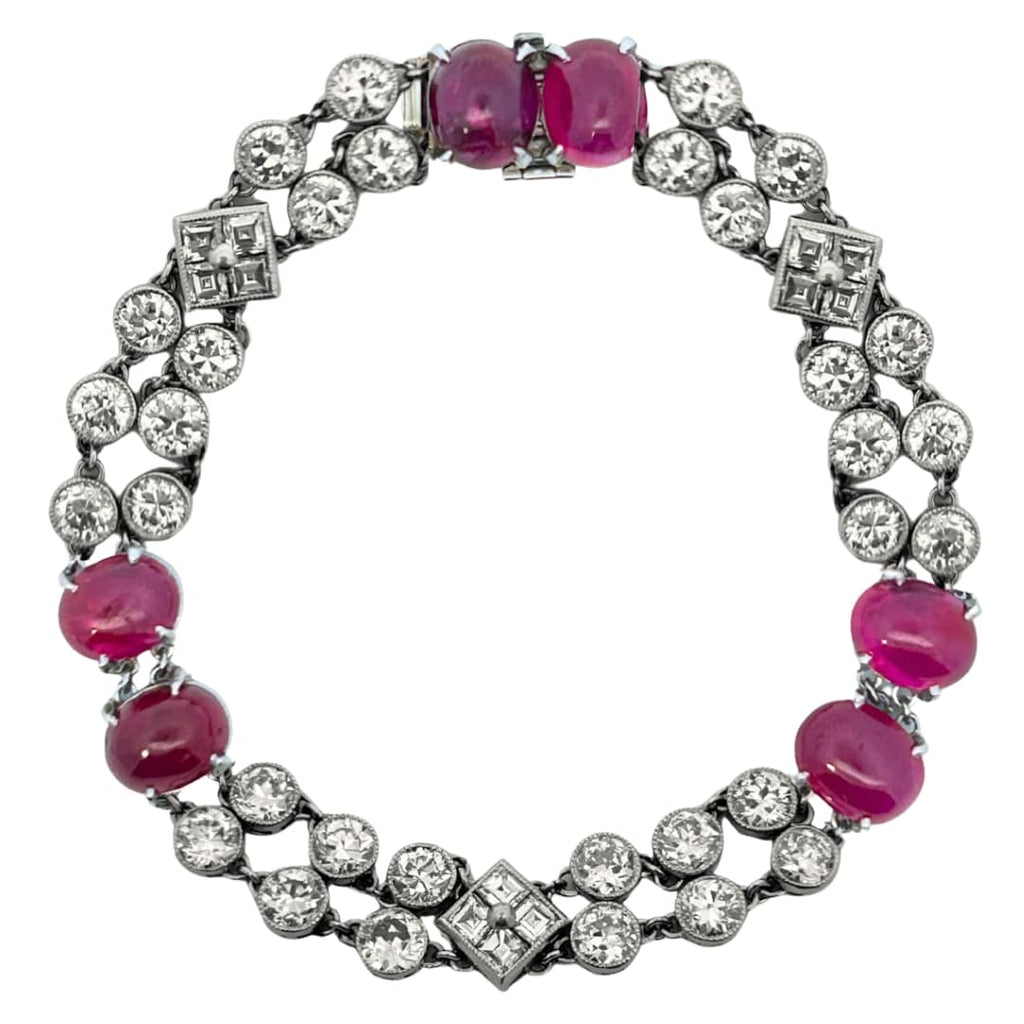 Circular view of Art Deco bracelet featuring ruby cabochons and bezel-set diamonds in platinum.