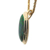 Side profile of black opal pendant showing double bezel and gold bail
