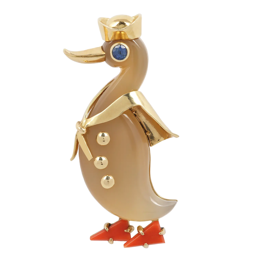 Vintage retro Cartier Sailor Duck Pin with a tan agate body, coral feet, blue sapphire eye and yellow gold details.