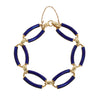 Estate bracelet with cobalt blue enamel oval links, 18K gold connectors, and safety chain clasp. Overhead view