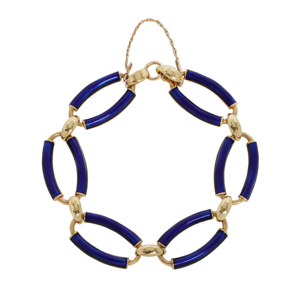 Estate bracelet with cobalt blue enamel oval links, 18K gold connectors, and safety chain clasp. Overhead view