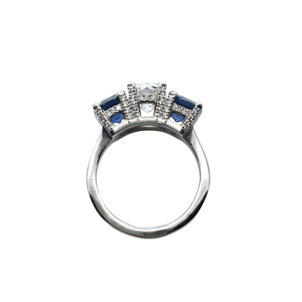 Side profile of cushion diamond and sapphire three-gemstone ring with pavé-set gallery and polished band