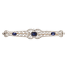 Antique Edwardian platinum wreath bar pin with 36 European-cut diamonds totaling approximately 1.29 carats and three cushion-cut synthetic sapphires.