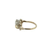 Angled view of Edwardian two-stone diamond and pearl ring with bead-set swirl accents.