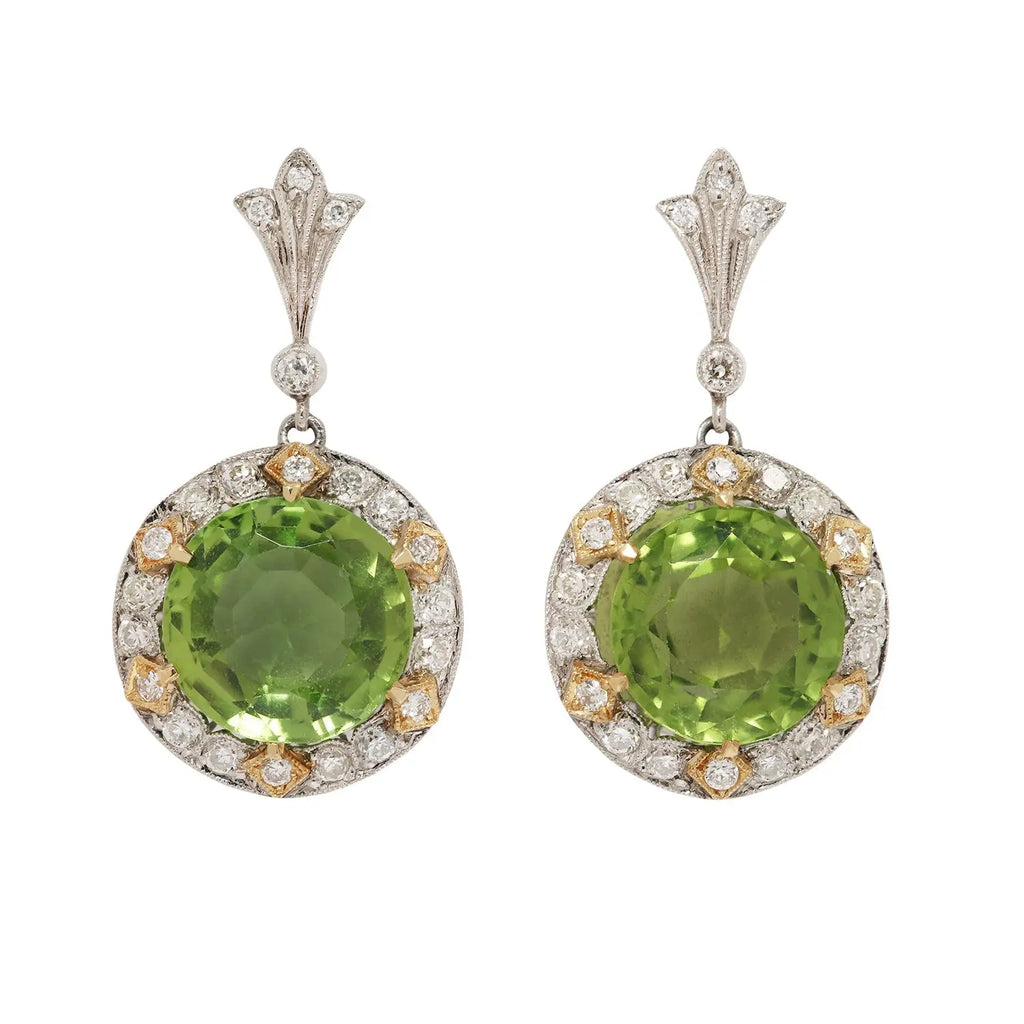 Stunning two-tone 18K gold drop earrings with large round peridots, diamond halo, and secure post-back closure.