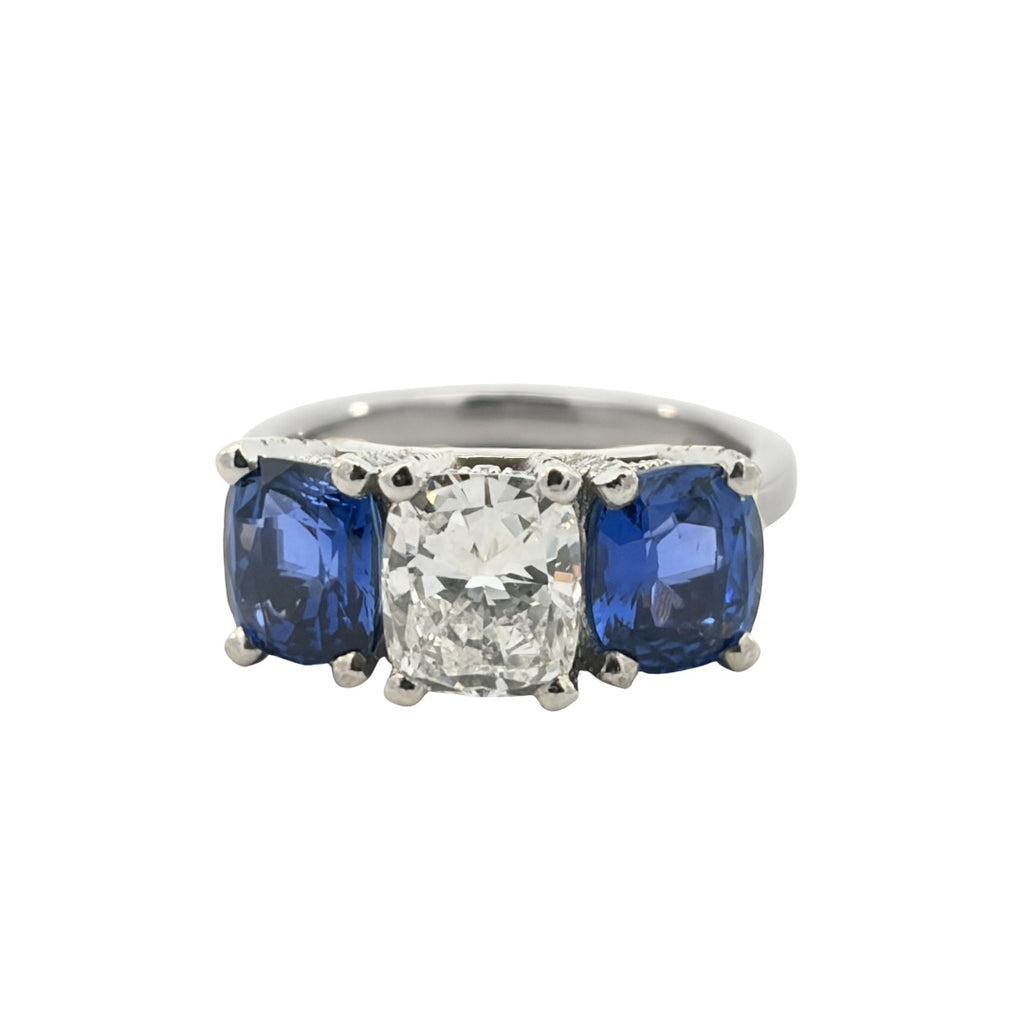 Front view of 2.02 carat cushion diamond ring flanked by two cushion-cut blue sapphires