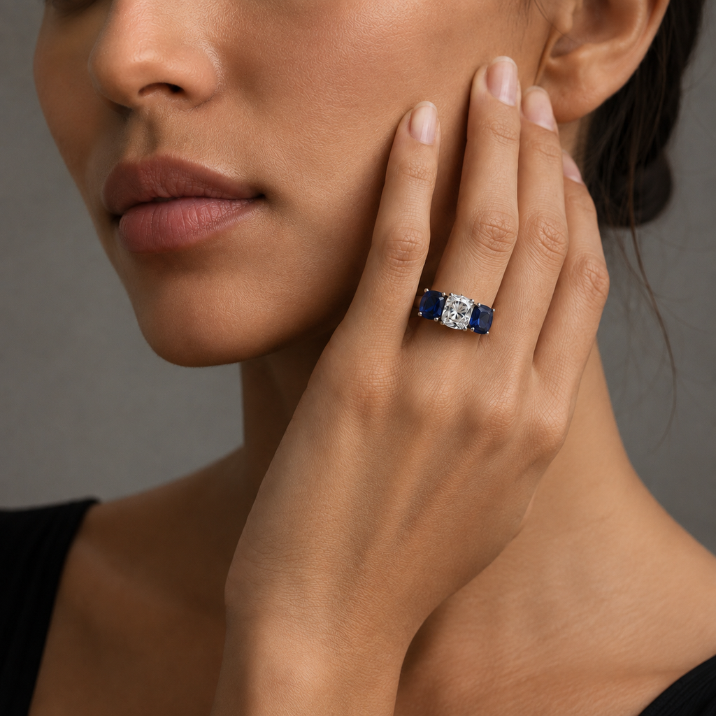 Front view of 2.02 carat cushion diamond ring flanked by two cushion-cut blue sapphires