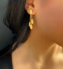 Siviglia gold earrings by Marco Bicego on model with dark hair.