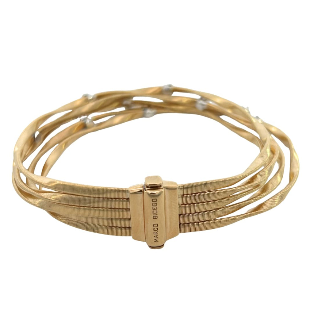 Side view of Marco Bicego’s 18k yellow gold Marrakech bracelet showing twisted gold strands and diamond accents.