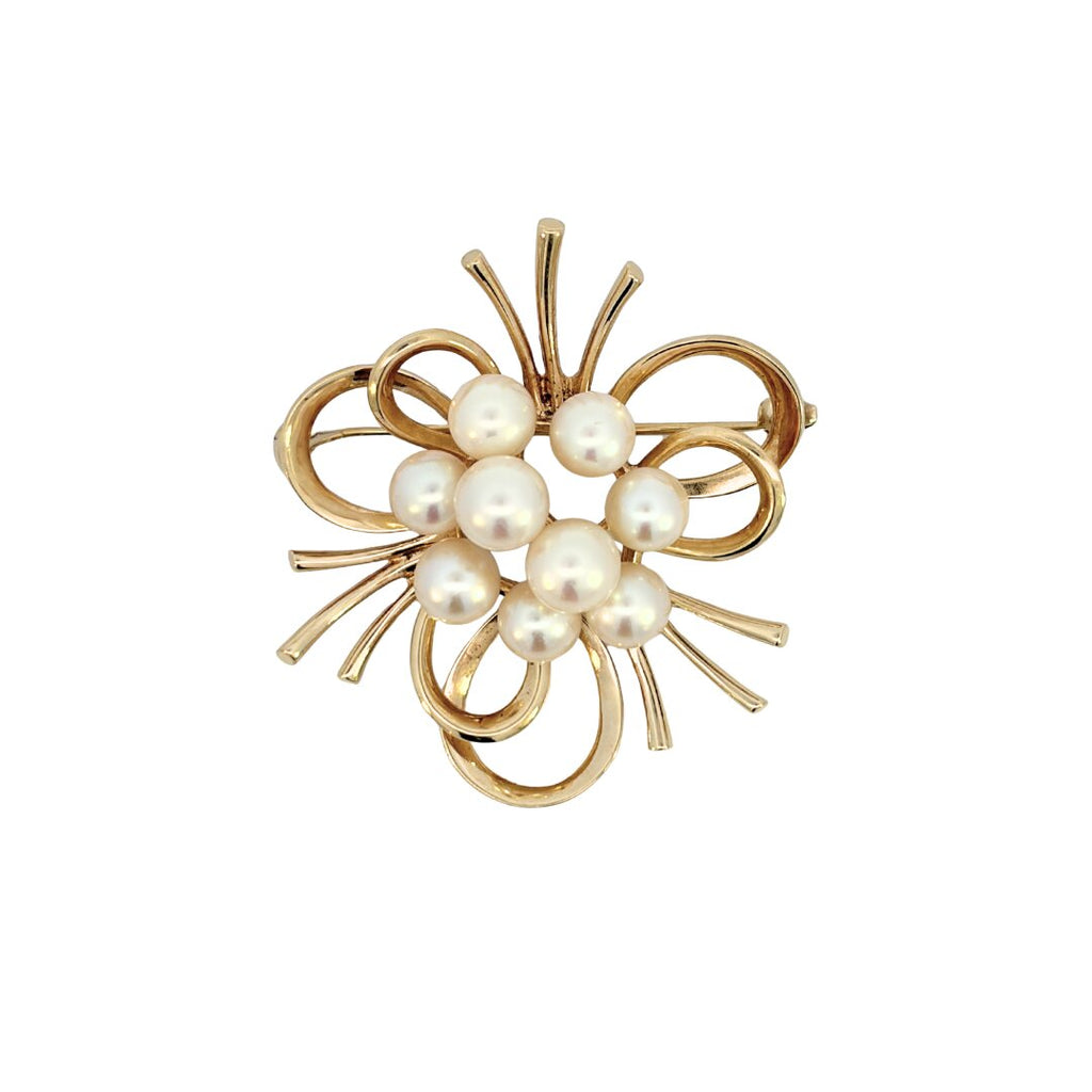 Front view of Mikimoto 14K yellow gold brooch with nine cultured pearls in a sculptural loop and wire cluster design