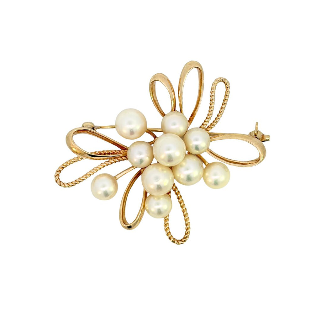 Front view of Mikimoto 14K yellow gold brooch with ten cultured pearls, polished loops, and twisted wire accents