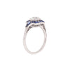 Side view of Old Mine Cut diamond ring with French-cut sapphire halo in platinum.