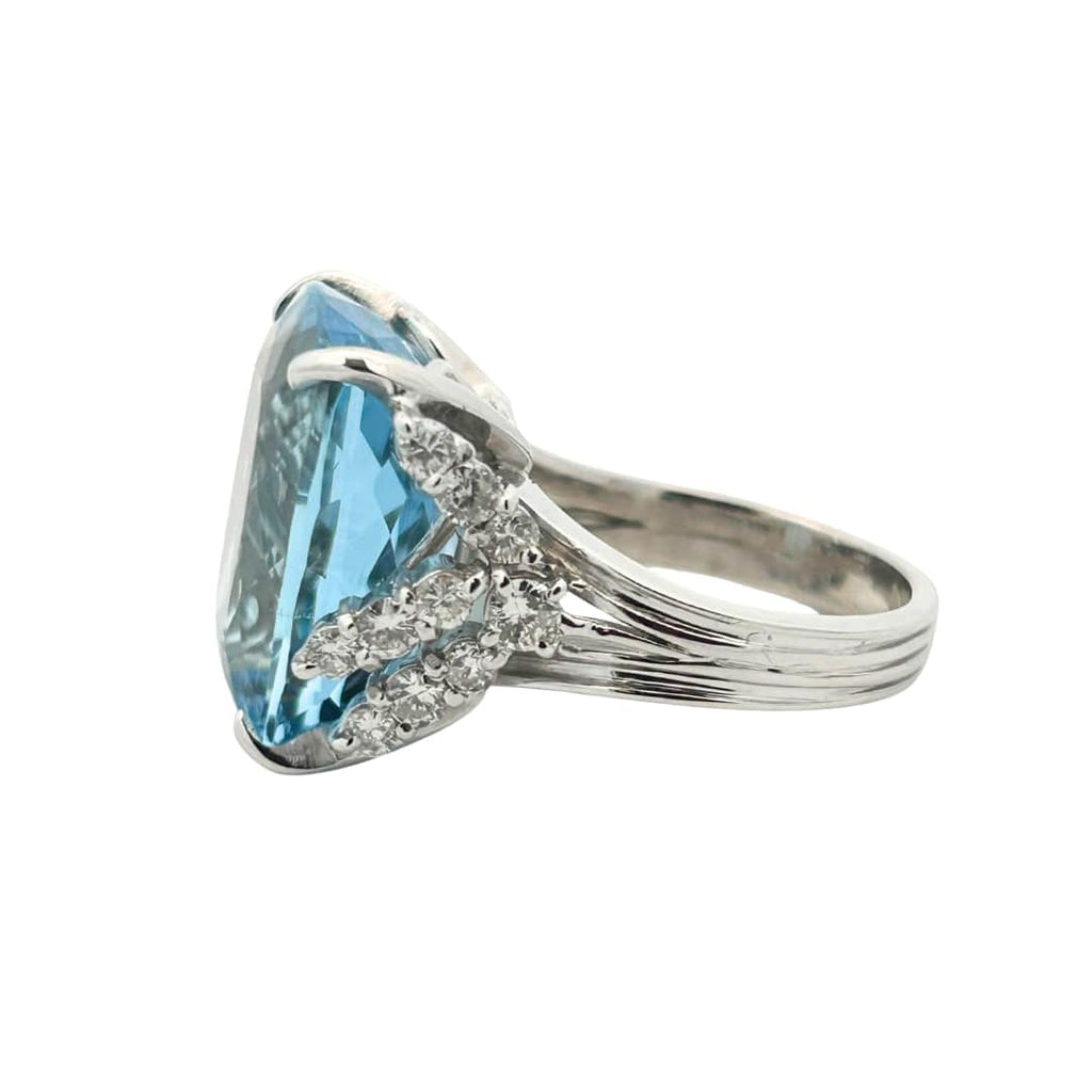 Side profile of vintage platinum ring with large cushion aquamarine and diamond accent detailing