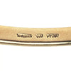 Interior view highlighting Tiffany & Co. hallmarks and the smooth polished finish of the 18k yellow gold Etoile bangle.
