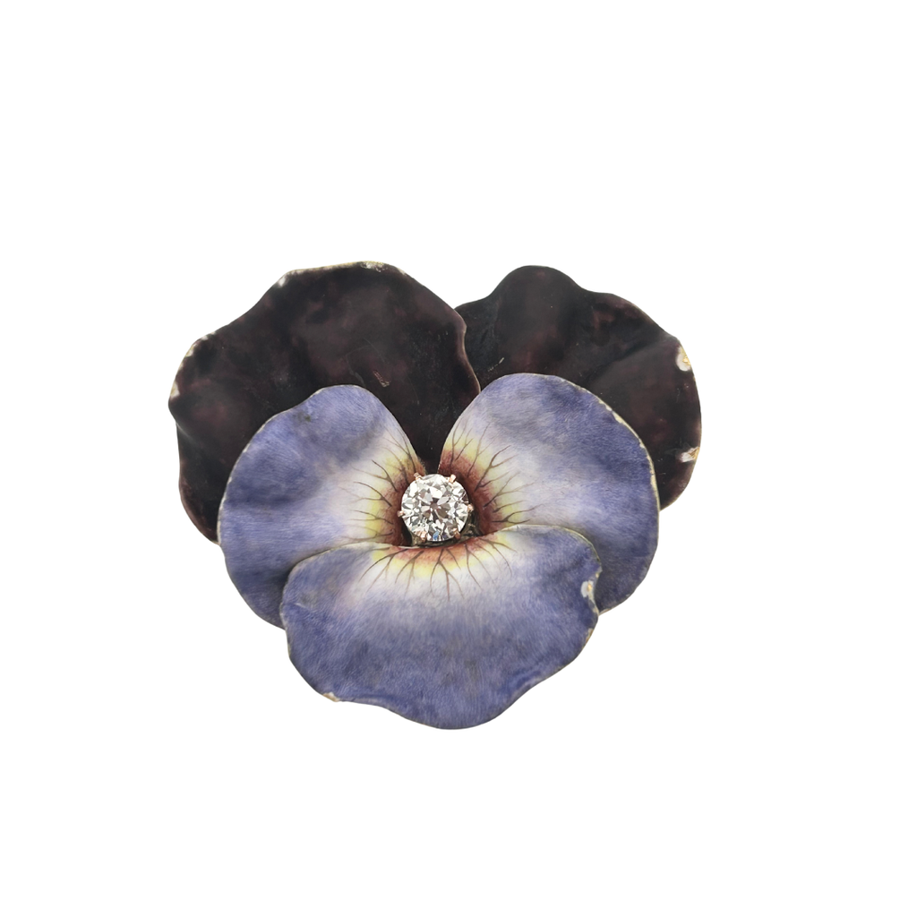 Front view of antique Victorian pansy brooch featuring purple enamel petals and Old Mine Cut diamond center.
