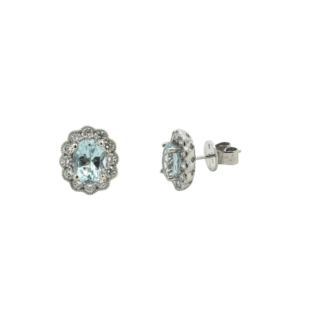 Aquamarine and diamond halo stud earrings showing 14k white gold scalloped setting.