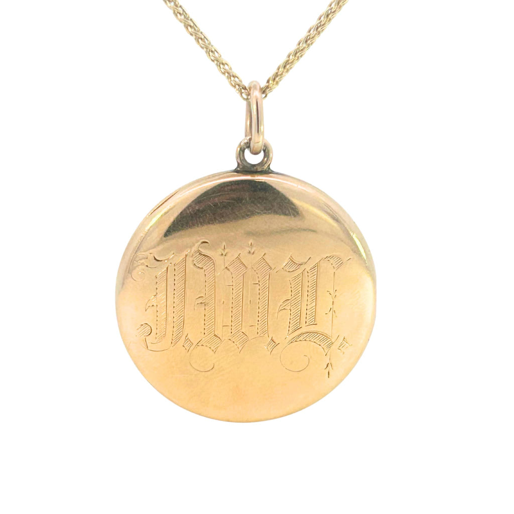 Antique Art Nouveau gold locket with raised profile of a woman, engraved monogram on reverse, and period photograph inside. Back.