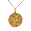 Antique Art Nouveau gold locket with raised profile of a woman, engraved monogram on reverse, and period photograph inside.