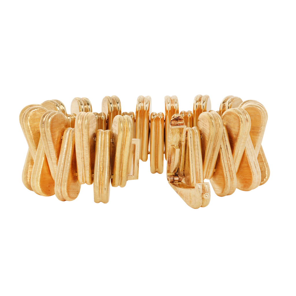 Vintage Cartier 18k yellow gold bracelet with alternating triangular links, Florentine engraved finish, and concealed foldover clasp; 7 inches.