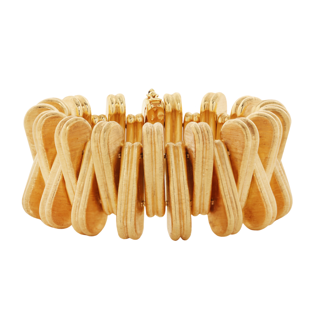 Vintage Cartier 18k yellow gold bracelet with alternating triangular links, Florentine engraved finish, and concealed foldover clasp; 7 inches.