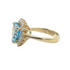 Angled profile of yellow gold aquamarine ring with diamond halo