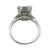 Platinum vintage emerald cut diamond engagement ring featuring a 6.02ct M/VS1 GIA-certified center stone with tapered baguette side diamonds.