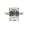 Platinum emerald cut diamond engagement ring featuring a 6.02ct M/VS1 GIA-certified center stone with tapered baguette side diamonds.