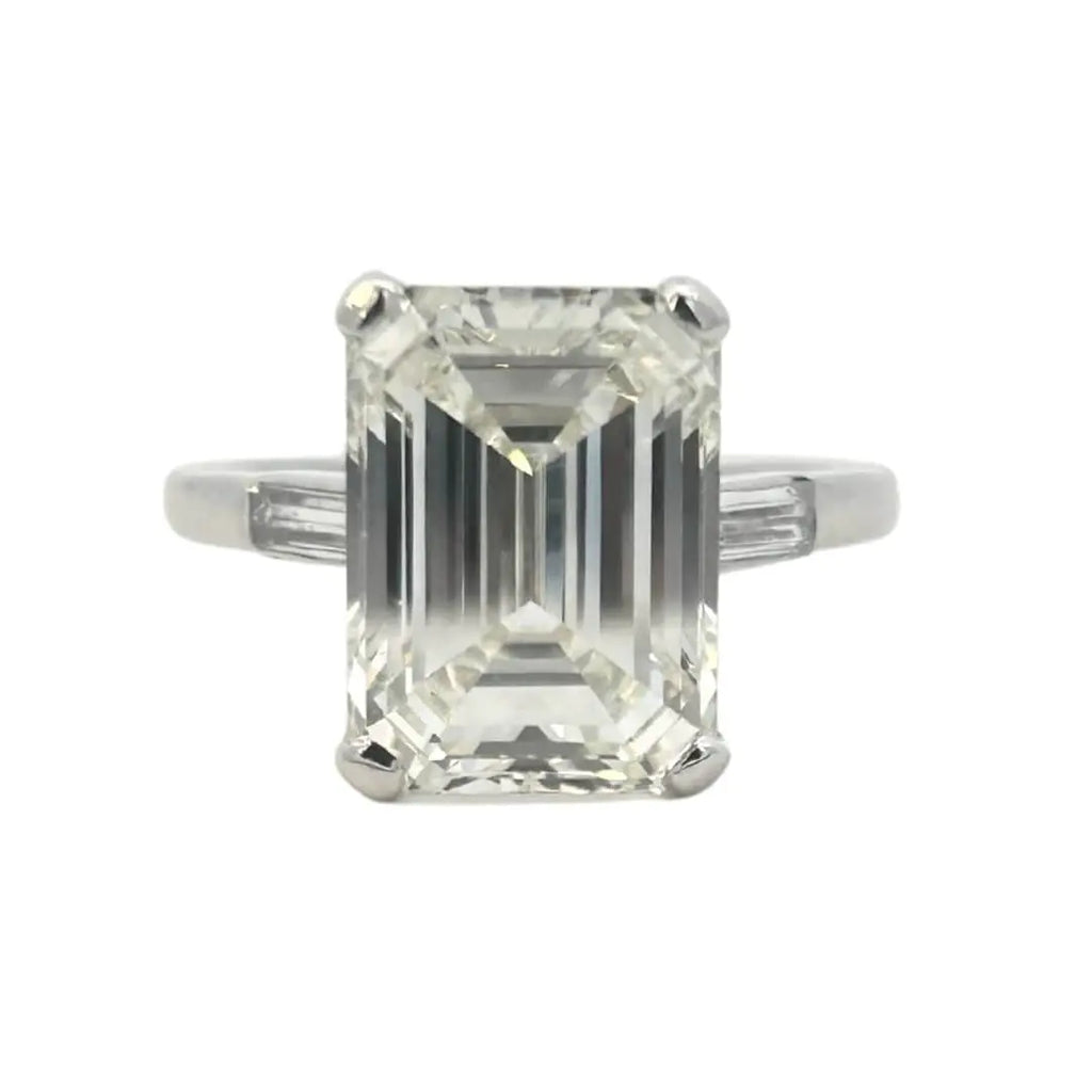 Platinum emerald cut diamond engagement ring featuring a 6.02ct M/VS1 GIA-certified center stone with tapered baguette side diamonds.