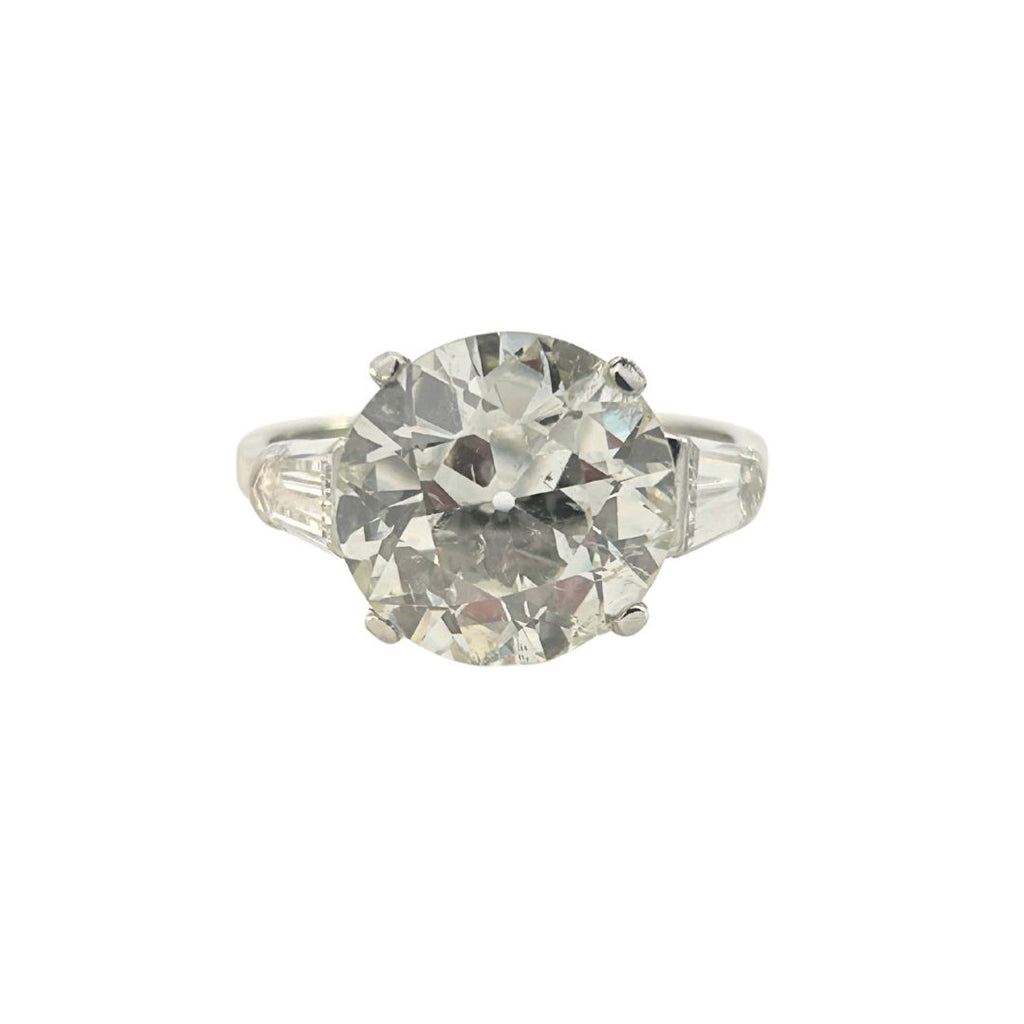 Platinum ring with a 4.95ct European–cut diamond flanked by bullet-shaped side diamonds
