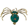 Back view of the spider brooch revealing the segmented enamel abdomen and engraved butterflies.