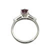 platinum ring with 0.84ct round pink sapphire flanked by tapered baguette diamonds totaling ~0.30ct.