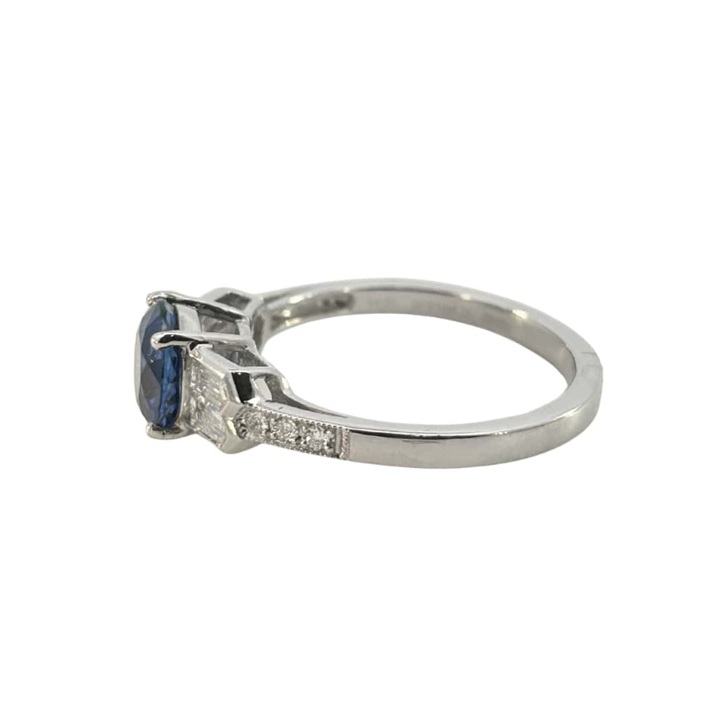 Side profile of the sapphire ring showing the stepped baguette settings and slim shank.