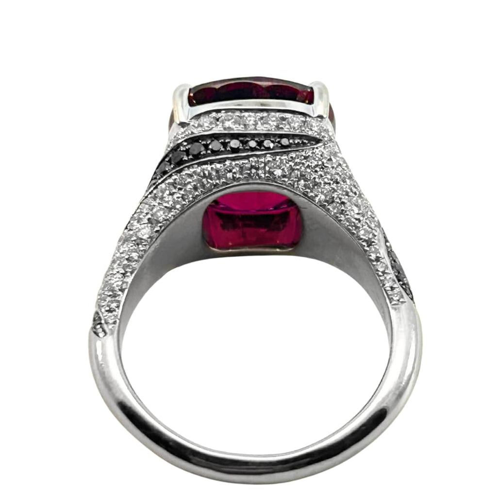 18k white gold rubellite and diamond cocktail ring with black diamond swirl accents and 5.35ct cushion-cut rubellite center. Side view.
