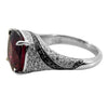 18k white gold rubellite and diamond cocktail ring with black diamond swirl accents and 5.35ct cushion-cut rubellite center.