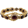 Front view of a 14k yellow gold bracelet with bezel-set star rubies and diamond accents in a rope-style setting.