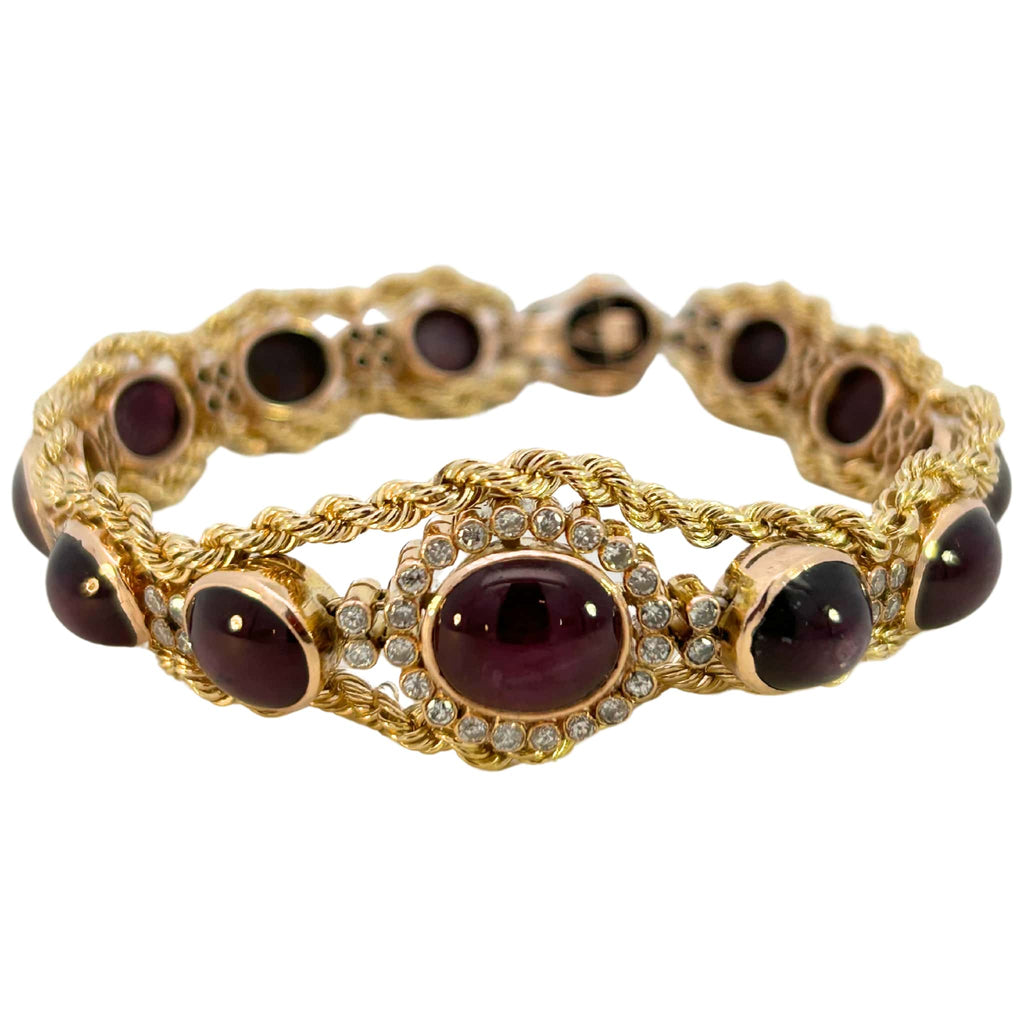 Front view of a 14k yellow gold bracelet with bezel-set star rubies and diamond accents in a rope-style setting.