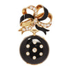 Convertible Tiffany & Co. black‑enamel lapel watch suspended from a diamond‑set gold bow brooch.