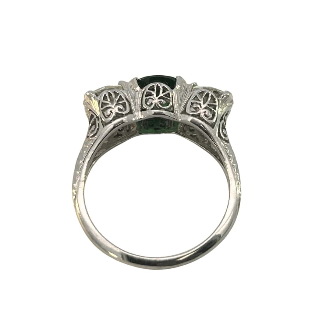 Underside of the platinum-style setting with decorative gallery work on a three-stone tsavorite and diamond ring.