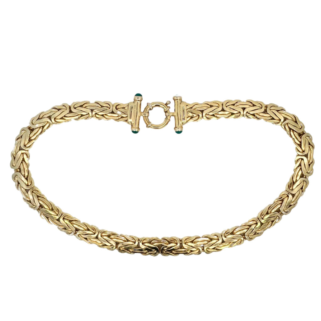 Full view of a 14k yellow gold Turkish link necklace with a large spring ring clasp and green onyx finials.