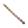 Gold amethyst bracelet with delicate pearl borders encircling each gemstone.