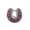 Front view of a Victorian horseshoe clip featuring rubies and antique diamonds in silver with a 10k gold back.