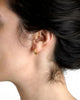 Baby hammered 19k yellow gold hoop earring shown worn on ear