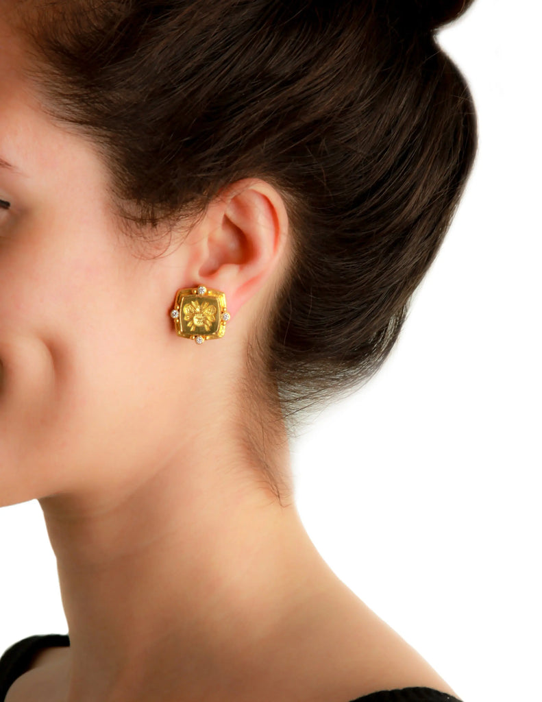 Gold bee and diamond earring in 19k yellow gold shown worn on ear